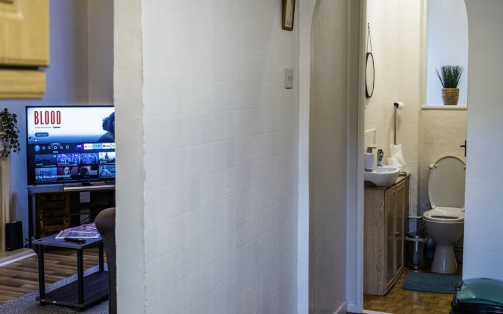 lodginet spacious white house living room and toilet